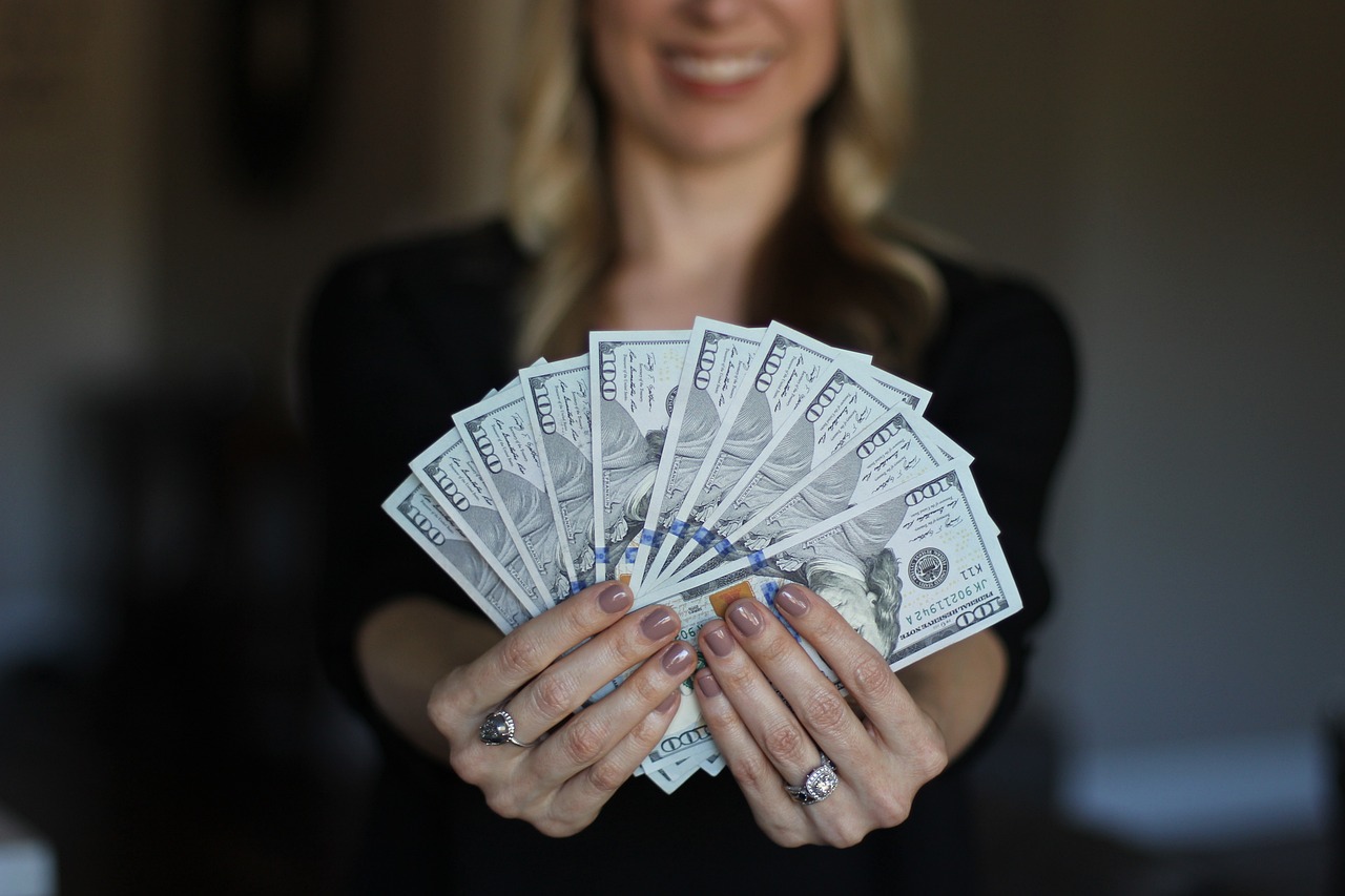 A photo holding several dollar bills.